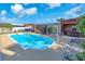 Backyard showcasing a sparkling pool, a hot tub, and outdoor lounge area for relaxation at 1012 Spindle Palm Way, Apollo Beach, FL 33572