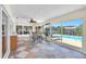 Bright sunroom featuring tile floors, ceiling fan, and glass doors that open to a pool area at 1012 Spindle Palm Way, Apollo Beach, FL 33572