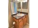 This bathroom features a vanity with a speckled countertop and a large mirror at 10316 Carrollwood Ct # 57, Tampa, FL 33618