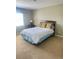 Comfortable bedroom featuring a full-sized bed, a work desk and a sunlit window, perfect for rest and productivity at 10316 Carrollwood Ct # 57, Tampa, FL 33618
