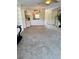 Spacious living room featuring neutral carpet and an open layout towards the kitchen at 10316 Carrollwood Ct # 57, Tampa, FL 33618