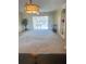 A spacious living room has a sliding door and a view of the exterior and features a built-in bookcase at 10316 Carrollwood Ct # 57, Tampa, FL 33618