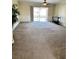 Large living room featuring carpet, sliding glass door to patio, and neutral wall color at 10316 Carrollwood Ct # 57, Tampa, FL 33618
