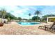A community swimming pool with lounge chairs offers a relaxing outdoor retreat at 10316 Carrollwood Ct # 57, Tampa, FL 33618