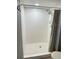 An all-white shower with a shower head and curtain at 10316 Carrollwood Ct # 57, Tampa, FL 33618