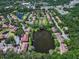 Aerial view of a community featuring multiple ponds, trees, and many residential buildings at 10849 Kensington Park Ave, Riverview, FL 33578