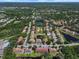 Aerial view of a community with trees, ponds, pools, and many residential buildings at 10849 Kensington Park Ave, Riverview, FL 33578