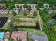Aerial view of the community, showing the pond, surrounding homes and lush landscaping at 10849 Kensington Park Ave, Riverview, FL 33578