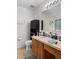 Bathroom featuring wood cabinets, single sink, large mirror, and ample countertop space at 10849 Kensington Park Ave, Riverview, FL 33578