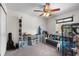Bedroom featuring natural light, a ceiling fan, and a gray couch at 10849 Kensington Park Ave, Riverview, FL 33578