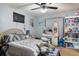 Bedroom featuring neutral walls, ceiling fan, decor, and a bed with silvery-gray bedding at 10849 Kensington Park Ave, Riverview, FL 33578