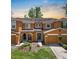 Charming townhome featuring an attached garage, manicured lawn, and inviting front entry at 10849 Kensington Park Ave, Riverview, FL 33578