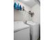 Laundry room featuring white walls, overhead storage, and a white washer and dryer at 10849 Kensington Park Ave, Riverview, FL 33578