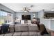 Inviting living room featuring a gray sofa, a flat-screen TV, and an open floor plan at 10849 Kensington Park Ave, Riverview, FL 33578