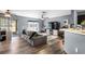 Bright living room with wood floors, sliding glass doors to the outside, and an open concept kitchen at 10849 Kensington Park Ave, Riverview, FL 33578