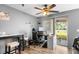 Office with desk, computer, and seating with sliding glass doors offering light and outdoor access at 10849 Kensington Park Ave, Riverview, FL 33578