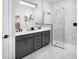 Modern bathroom featuring double sinks, a glass-enclosed shower, and marble accents at 11288 Boundless Ter, Venice, FL 34293