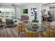 Bright living room with a glass table, modern furniture, and a view of the backyard at 11288 Boundless Ter, Venice, FL 34293