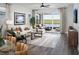 Comfortable living area with a plush sofa, decorative pillows, and sliding glass doors to the patio at 11288 Boundless Ter, Venice, FL 34293