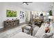 Spacious living room with a comfortable sofa, media cabinet, and an open view to the kitchen area at 11288 Boundless Ter, Venice, FL 34293