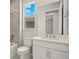 Bathroom featuring a shower, toilet, sink, large mirror and vanity with quartz countertops at 11290 Boundless Ter, Venice, FL 34293