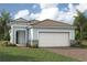 Charming single-Gathering home showcasing a well-maintained lawn and a two-car garage at 11290 Boundless Ter, Venice, FL 34293