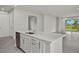 Well-appointed kitchen island with stainless steel dishwasher, sink, and ample counter space at 11290 Boundless Ter, Venice, FL 34293