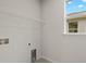 This laundry room has neutral walls and tile flooring at 11290 Boundless Ter, Venice, FL 34293