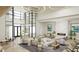 Elegant lobby with high ceilings, modern lighting, comfortable seating and fireplace at 11290 Boundless Ter, Venice, FL 34293
