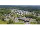 Aerial view of a 55+ community with trees and ponds throughout on a sunny day at 11728 Carissa Ln # 0, New Port Richey, FL 34654