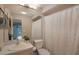 Neutral bathroom with a shower-tub combination, vanity, and decorative mirror at 11728 Carissa Ln # 0, New Port Richey, FL 34654