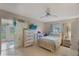Bright bedroom with beach-themed decor, a ceiling fan, and sliding glass door at 11728 Carissa Ln # 0, New Port Richey, FL 34654