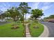 Inviting community green space with benches, walking path, landscaping, and mature trees at 11728 Carissa Ln # 0, New Port Richey, FL 34654