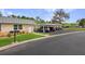 Well-maintained condo exterior with stone accents, lawn, and covered parking in a desirable community at 11728 Carissa Ln # 0, New Port Richey, FL 34654