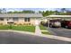Charming condo exterior with stone accents, lush lawn, covered parking, and well-maintained landscaping at 11728 Carissa Ln # 0, New Port Richey, FL 34654