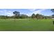Wide view of the well maintained golf course on a sunny day with trees throughout at 11728 Carissa Ln # 0, New Port Richey, FL 34654
