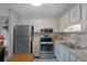 Bright kitchen featuring stainless steel appliances, and ample cabinet space at 11728 Carissa Ln # 0, New Port Richey, FL 34654