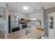 Modern kitchen with stainless steel appliances, white cabinetry, and wood-topped island at 11728 Carissa Ln # 0, New Port Richey, FL 34654