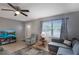 Cozy living room features neutral colors, ceiling fan, comfortable seating, and a large window at 11728 Carissa Ln # 0, New Port Richey, FL 34654