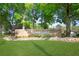 Community sign for Summertree with manicured lawn and mature trees providing a welcoming entrance at 11728 Carissa Ln # 0, New Port Richey, FL 34654