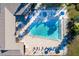 Aerial view of a community pool with sun loungers and umbrellas for residents' relaxation at 1203 16Th Se Cir, Largo, FL 33771