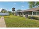 A spacious backyard with lush green grass and mature landscaping at 1203 16Th Se Cir, Largo, FL 33771