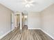 Cozy bedroom featuring wood floors, neutral tones and an ensuite bath for added convenience at 1203 16Th Se Cir, Largo, FL 33771