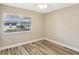 This bedroom features natural light from the window and stylish wood floors at 1203 16Th Se Cir, Largo, FL 33771