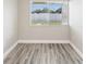 Bright, neutral bedroom with vinyl floors and a view to the exterior at 1203 16Th Se Cir, Largo, FL 33771