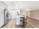 Bright kitchen with white cabinets, breakfast bar, and stainless steel refrigerator at 1203 16Th Se Cir, Largo, FL 33771