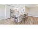 Bright kitchen with stainless steel refrigerator, lots of storage, a white countertop bar, and new gray flooring at 1203 16Th Se Cir, Largo, FL 33771