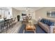 Cozy living area with a dining room, a modern kitchen bar, new flooring, and stylish decor at 1203 16Th Se Cir, Largo, FL 33771