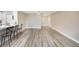 Expansive living space featuring modern flooring, neutral walls, a kitchen bar, and abundant natural light at 1203 16Th Se Cir, Largo, FL 33771
