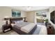 The main bedroom features a sliding glass door, neutral decor, and an en suite bathroom at 1203 16Th Se Cir, Largo, FL 33771